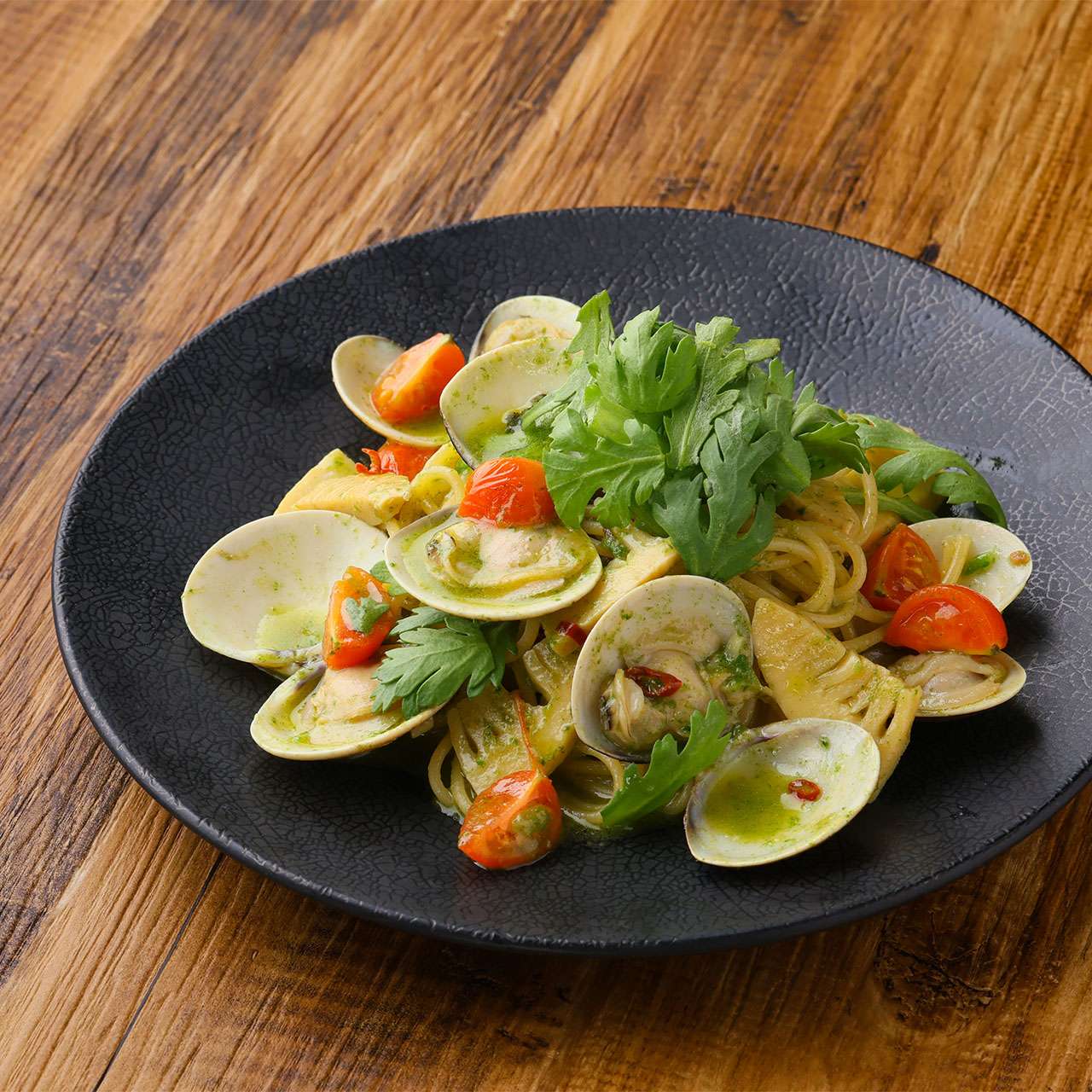 Clams and bamboo shoots in a garland of chrysanthemum pesto