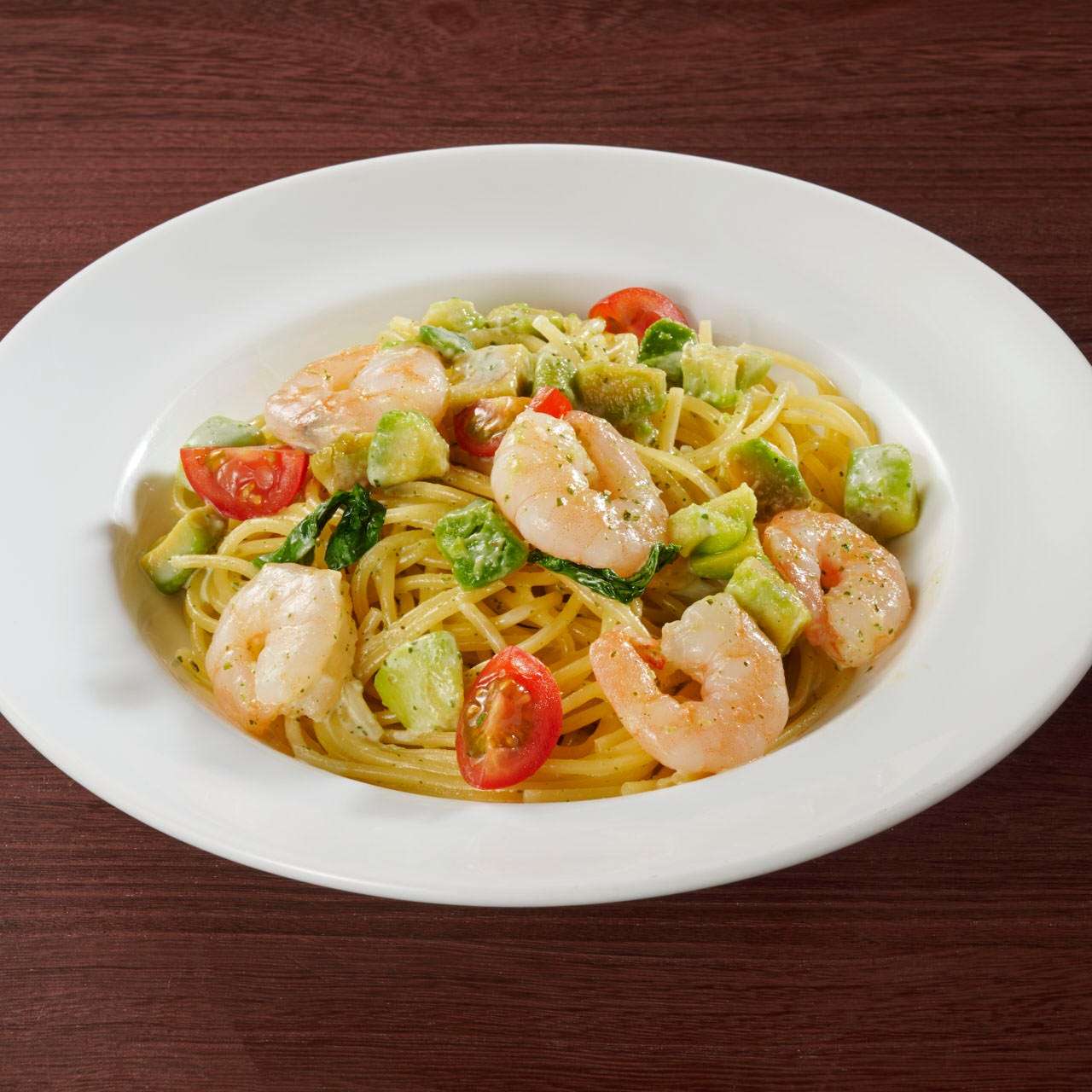 Shrimp and avocado spaghetti with basil cream sauce