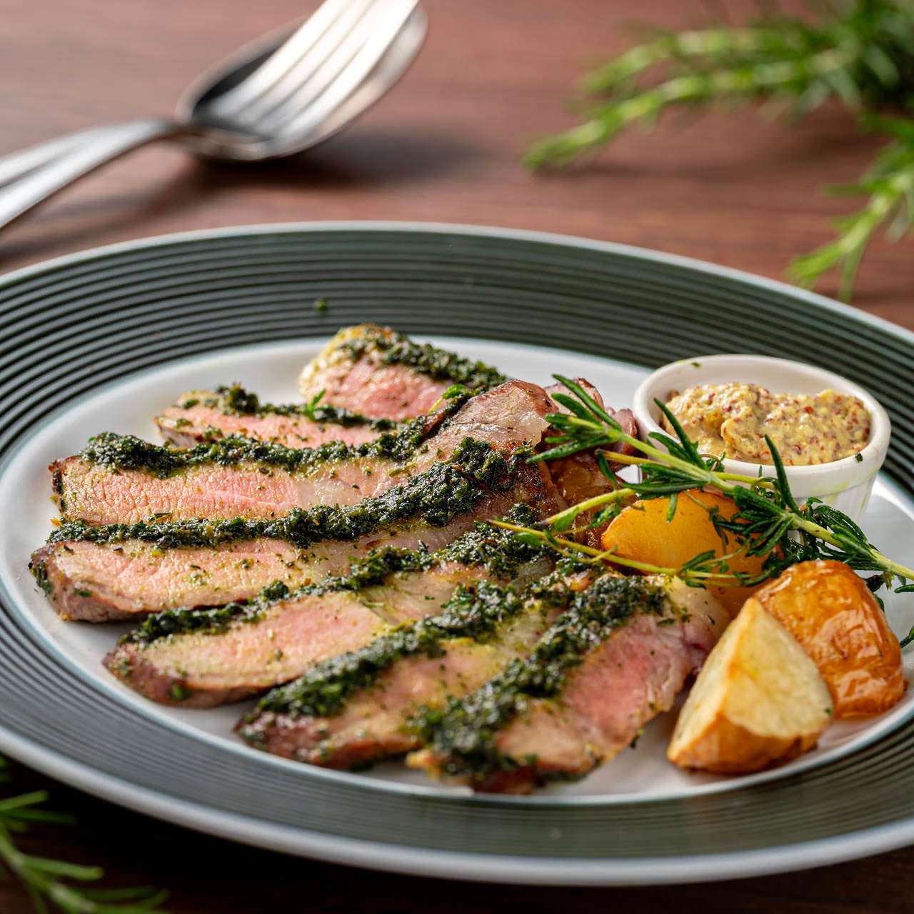 Roasted aged black pork with herb aroma, pickles and mustard sauce