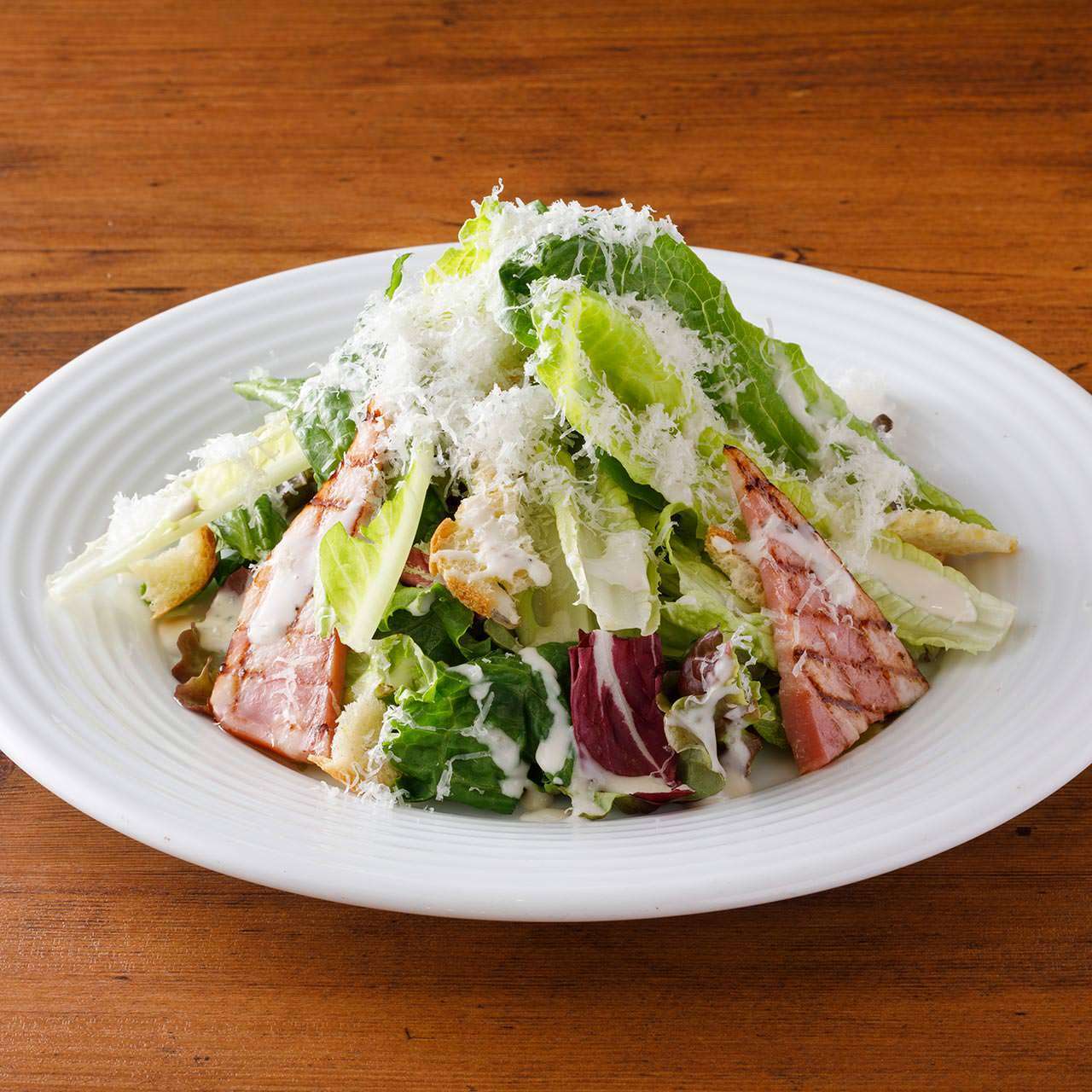 Caesar salad with grilled bacon and grana cheese