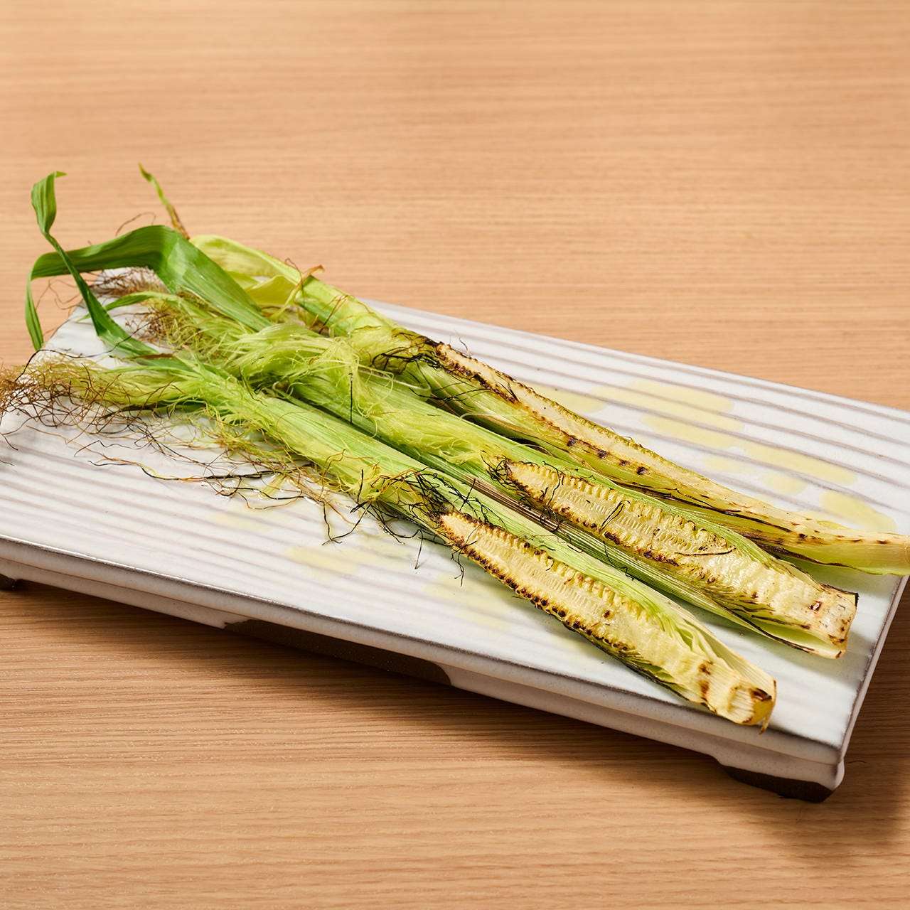 Roasted young corn with husk