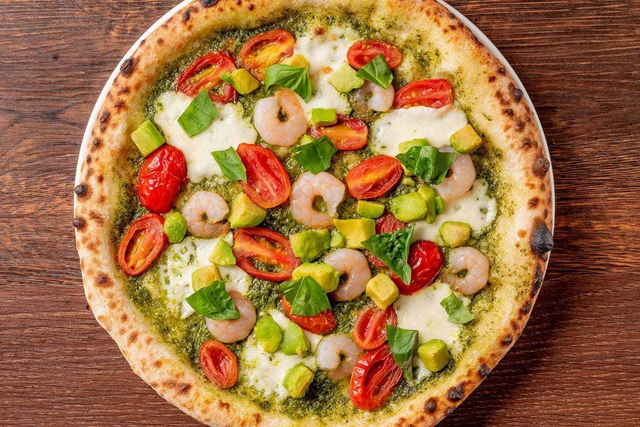 Shrimp, avocado, and pure sweet tomato pizza with pesto sauce