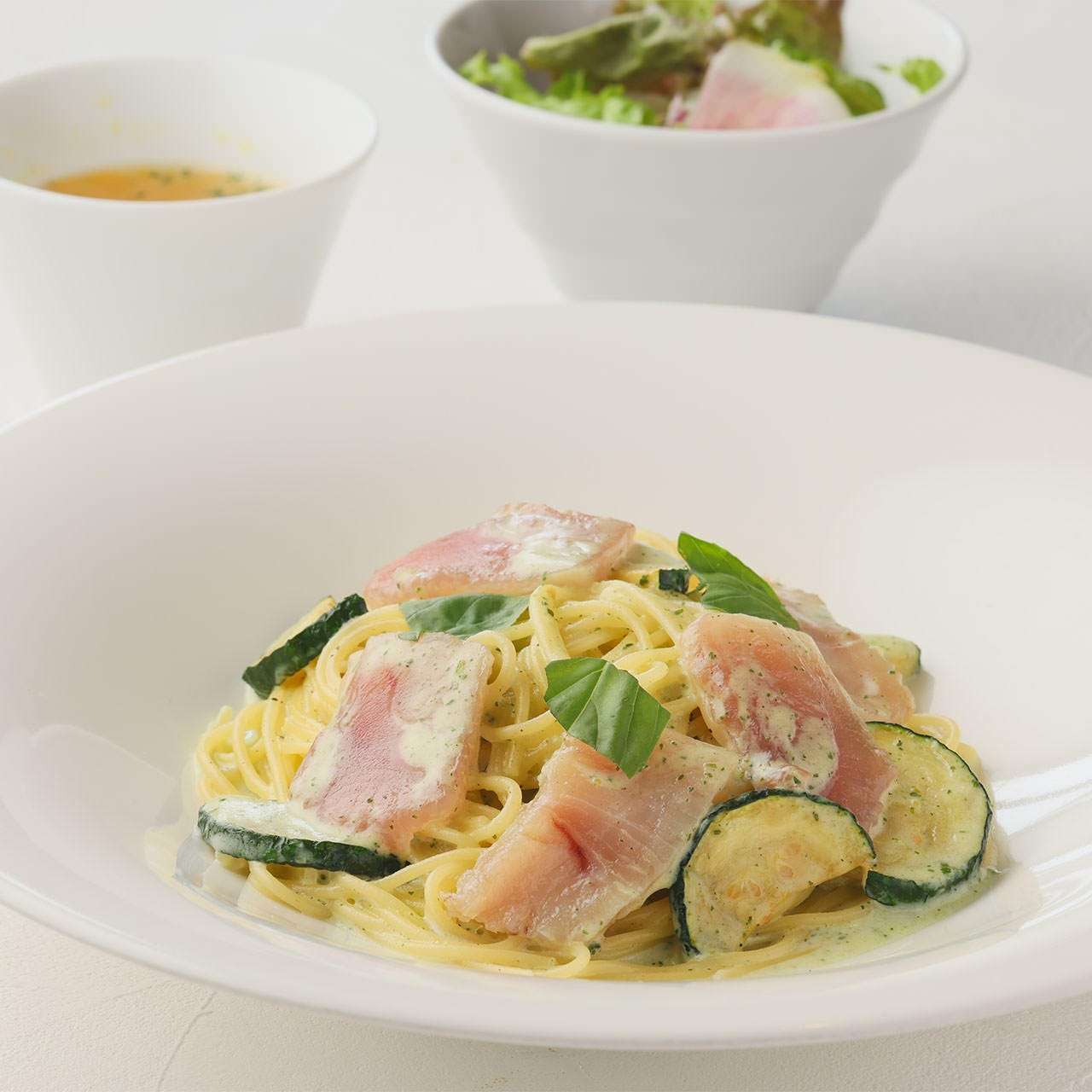 Spaghetti with albacore tuna, prosciutto and zucchini in basil cream sauce