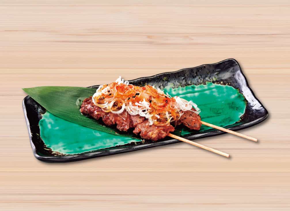 Grilled lamb skewers with plenty of green onion and wild garlic sauce