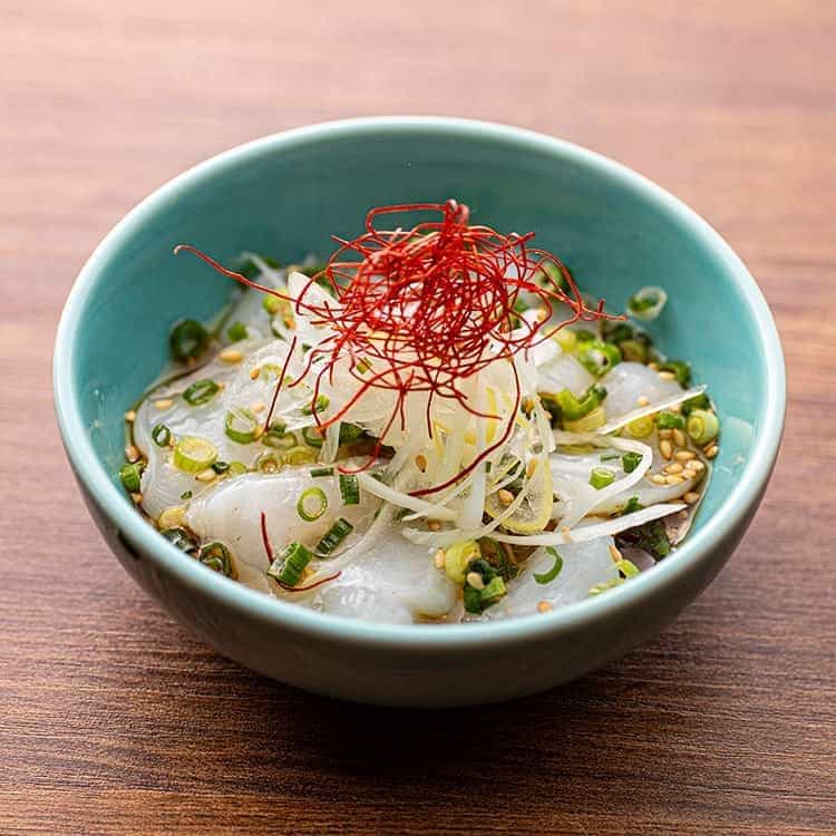 Raw octopus dressed with salt and sesame oil