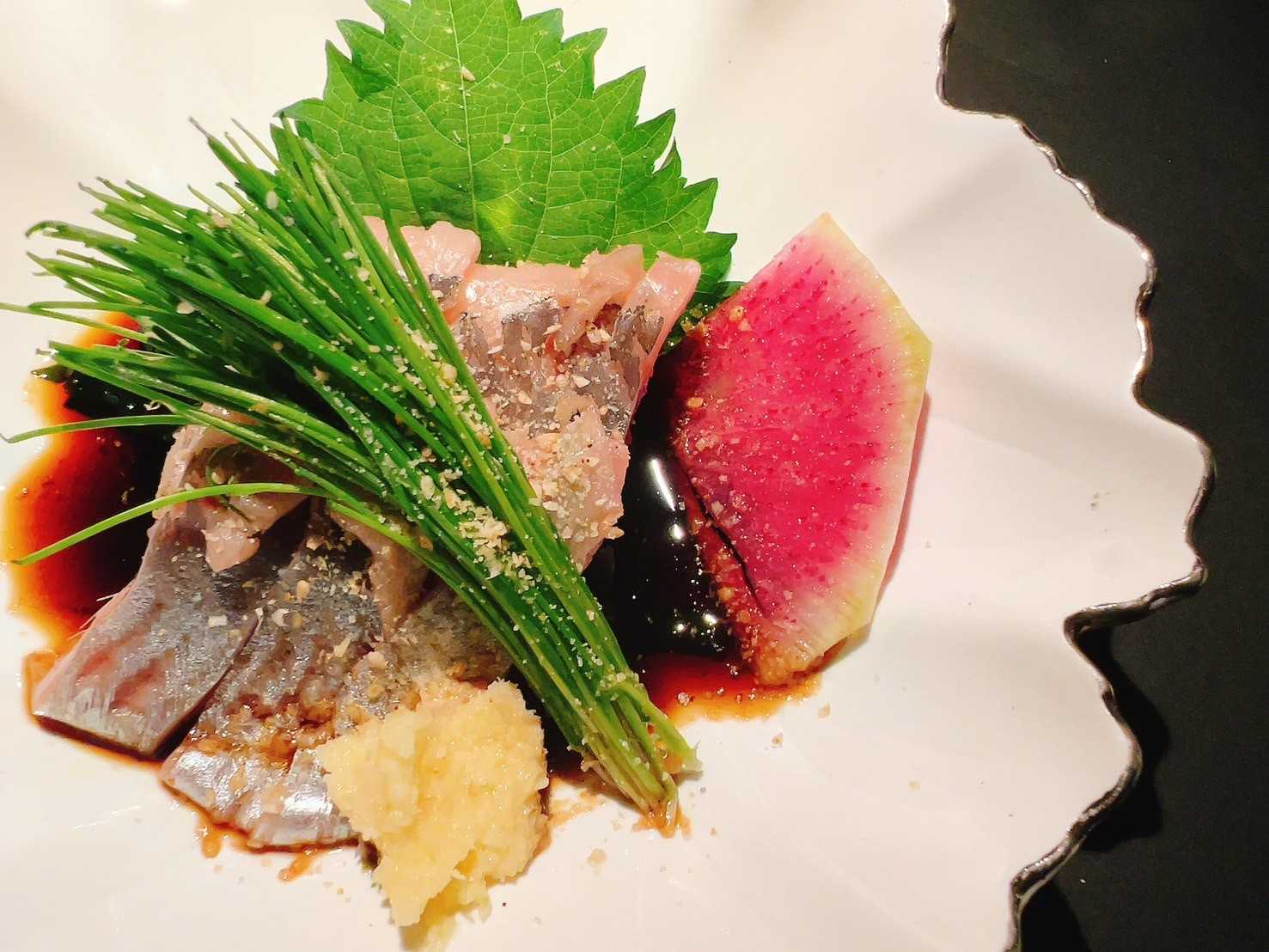Herring sashimi and green onion sprouts in ginger soy sauce